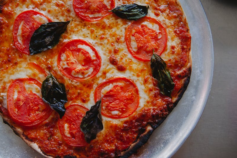 Classic Margherita thin crust pizza with fresh basil