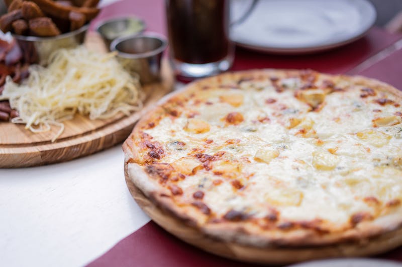 Four cheese thin crust pizza with mozzarella and parmesan
