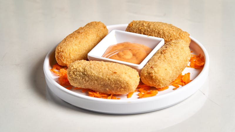 Golden mozzarella sticks with dipping sauce
