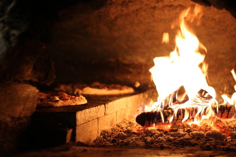 Pequod's pizza kitchen team collaborating on pequods pizza preparation